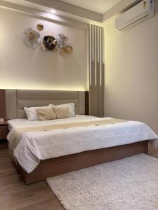 a bedroom with a large bed and a rug at The Kaksh in Greater Noida