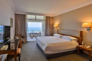 a hotel room with a bed and a balcony at Portemilio Hotel & Resort in Jounieh