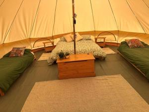 a room with two beds in a tent at Glamping Tent - Bell Tent in Brackley +3 photos