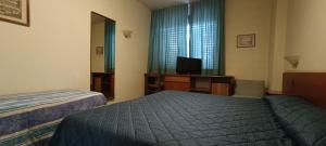 a hotel room with two beds and a television at Park Hotel Galileo in Reggello +55 photos