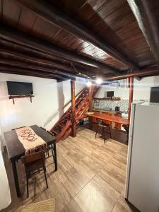 a kitchen and dining room with a table and a refrigerator at Dulce Claudina 3 in Mercedes