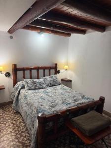 a bedroom with a large bed with a wooden frame at Dulce Claudina 3 in Mercedes