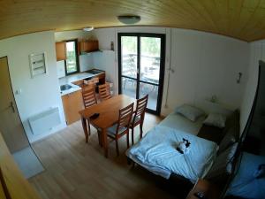 a room with a table and a bed and a kitchen at Chaty u Martiny in Nalžovice +27 photos