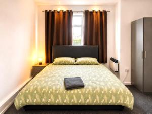 a bedroom with a large bed and a window at Middlesbrough The Longlands Hotel in Middlesbrough