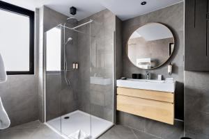 a bathroom with a shower and a sink and a mirror at Les Chalets du Grand Hôtel in Saint-Chaffrey +282 photos