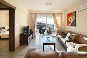 a living room with a couch and a table at Chloraka Terrace Apartments in Paphos City