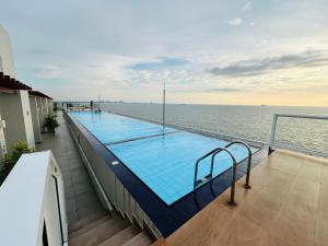 a swimming pool on the balcony of a building at Beach Front 2 by A & A Villas in Uswetakeiyawa