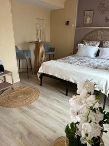 a bedroom with a bed and a table and chairs at Le nid gourmand in Andryes