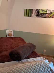 a bedroom with a bed with a picture on the wall at Maison carole in Fressac