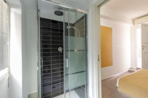 a glass shower in a room with a bed at Rooftop St. Peter in Rome +29 photos