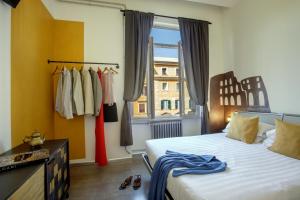 a bedroom with a bed and a window and clothes racks at Rooftop St. Peter in Rome