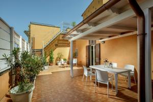 an outdoor patio with a white table and chairs at Rooftop St. Peter in Rome