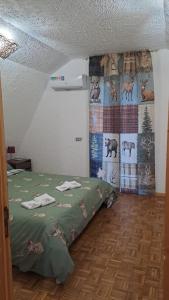 a bedroom with a bed and a wall with animals at Chalet Etna dreamers in Nicolosi