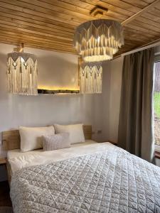 a bedroom with a large bed and chandeliers at Secret place in Svalyava