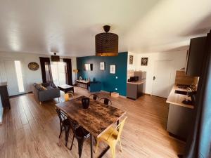 a living room with a wooden table and a dining room at Villa Alba in Auménancourt-le-Petit