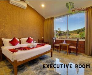 a hotel room with a bed and a large window at Forest County Resort Mahabaleshwar in Mahabaleshwar