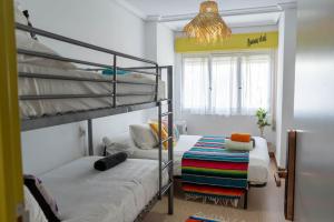 a bedroom with two bunk beds and a chandelier at Cactus by Arenas in Salinas