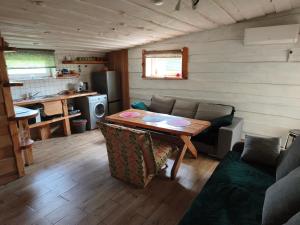 a living room with a table and a couch at Sodyba Valdo kubilas in Trakai +25 photos