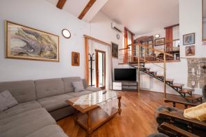 a living room with a couch and a table at Moonvidal residence with big private swimming pool and free parking in Pula