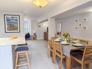 a dining room and living room with a table and chairs at Sandlands - Perfect central location in Ryde