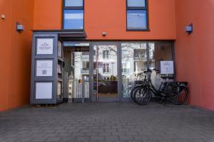 two bikes are parked outside of a building at med Apart in Erlangen