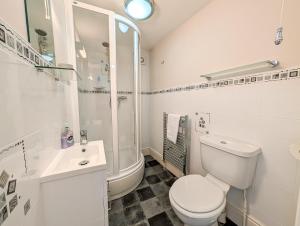 a white bathroom with a toilet and a sink at Sandlands - Perfect central location in Ryde +19 photos