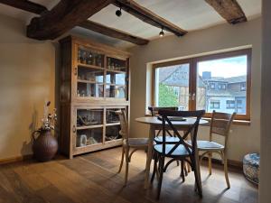 a dining room with a table and chairs and a window at Ferienhaus Sterntaler mit Sauna in Schwalmstadt