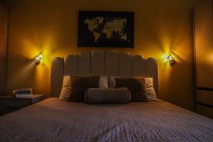 a bedroom with a large white bed with two lights at D&N Adriatic Nest in Kotor