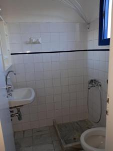 a bathroom with a sink and a toilet at Pyrgis Glyfades studios in Glifades