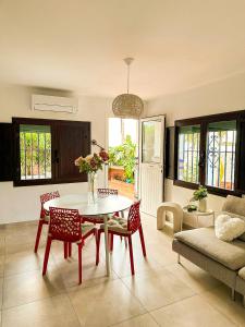 a living room with a table and chairs and a couch at La Chinita in Nerja +27 photos