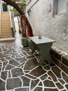 a white table sitting on a stone patio at Galini Pension in Ios Chora +69 photos