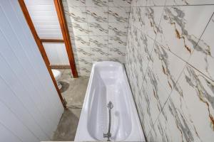 a bathroom with a bath tub and a toilet at Road Beach Cottages in Nusa Penida +32 photos