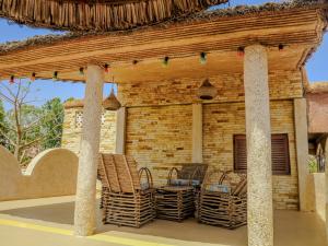 an outdoor patio with chairs and a pavilion at La Maison Chocolat in Nianing
