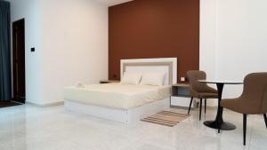 a bedroom with a bed and a table and chairs at A One Resort in Negombo
