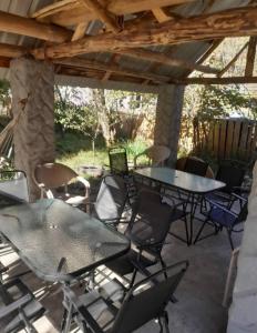 a patio with tables and chairs under a wooden roof at Hotel Dede in Lentekhi