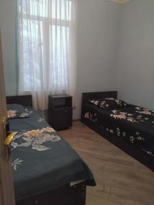 a bedroom with two beds and a window at Hotel Dede in Lentekhi