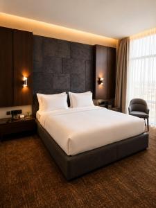 a large white bed in a hotel room at Baghdad Do Hotel in Baghdād +40 photos