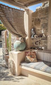 a porch with a vase sitting on a bench at Hamilton - Sohoros in Kámpos
