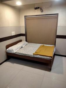 a bed in a small room with at Balaji rooms&domentry in Surat