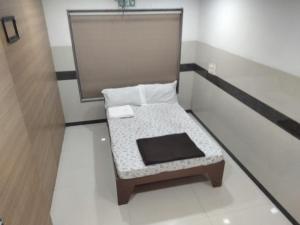 a small bench sitting in a room at Balaji rooms&domentry in Surat