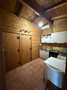 a kitchen with wooden walls and a table and a counter at Campeggio Il Delfino in Rocca Imperiale