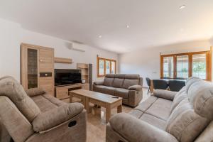 a living room with two couches and a tv at Luxury Getaway in Girona in Riudellots de la Selva
