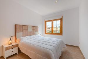 a white bedroom with a large bed and a window at Luxury Getaway in Girona in Riudellots de la Selva +22 photos