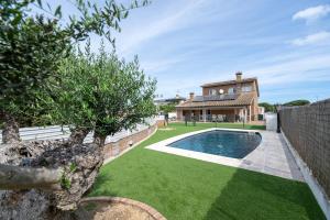 a yard with a swimming pool and a house at Luxury Getaway in Girona in Riudellots de la Selva