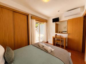 a bedroom with a bed with a towel on it at Aqua Gerês in Geres