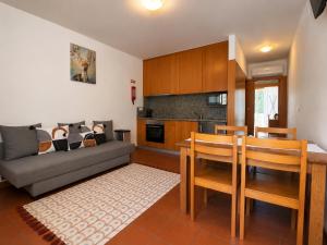 a living room with a couch and a table and chairs at Aqua Gerês in Geres