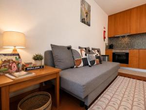 a living room with a couch and a table at Aqua Gerês in Geres +29 photos