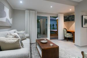 a living room with a couch and a coffee table at Lagoon Point Lodge in Knysna
