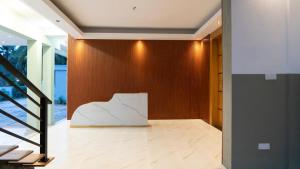 a lobby with a white sculpture on a wooden wall at A One Resort in Negombo +11 photos
