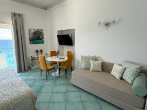 a living room with a couch and a table at Casa Adelaide in Capri